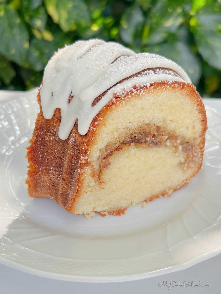 a bundt cake with icing on a white plate