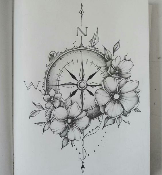 a black and white photo of a clock with flowers on the front, and an arrow in the back