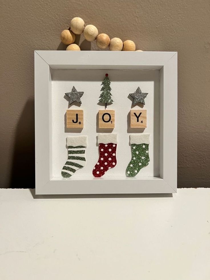 a white frame with wooden blocks and christmas decorations