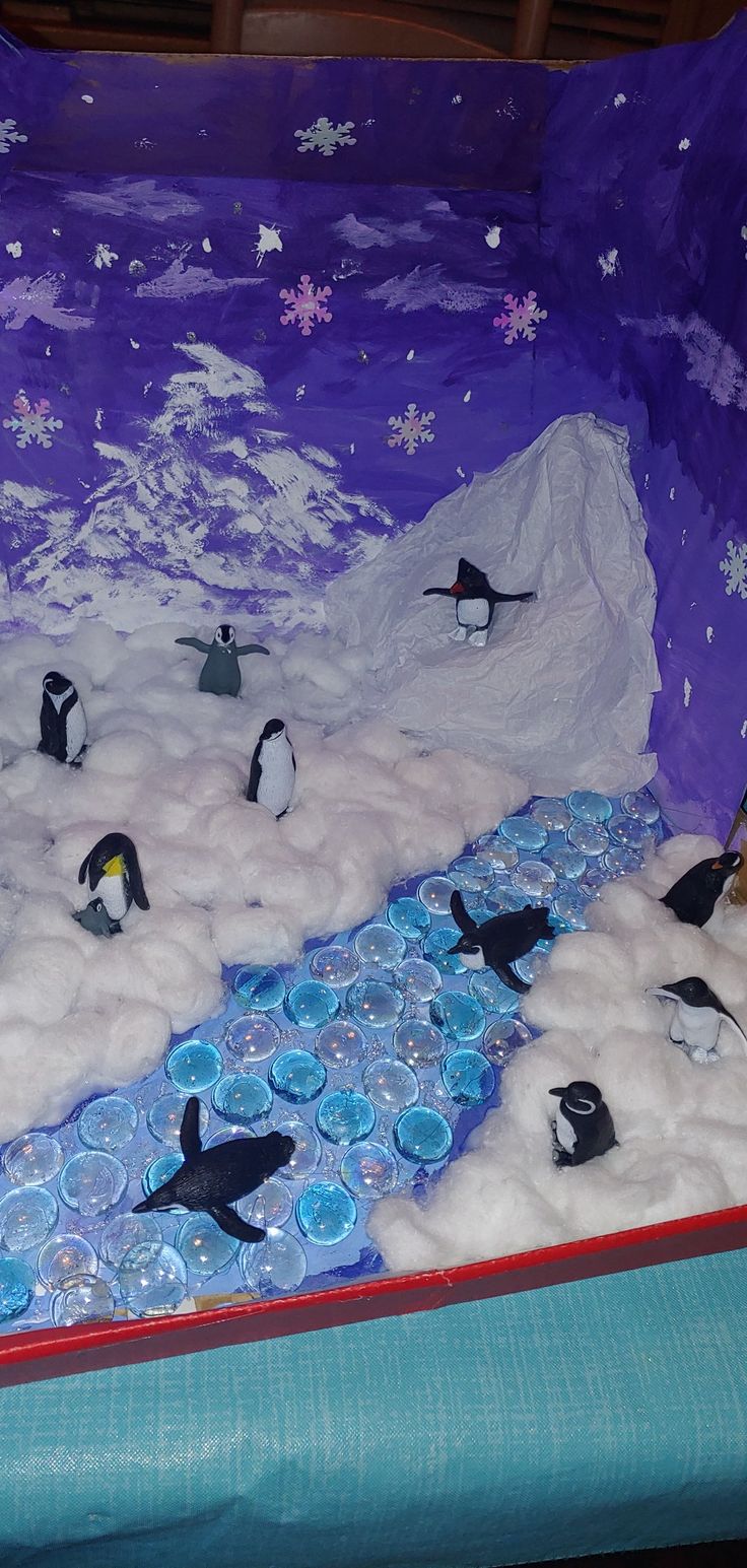 there are many penguins that are in the snow and water on this bedding set