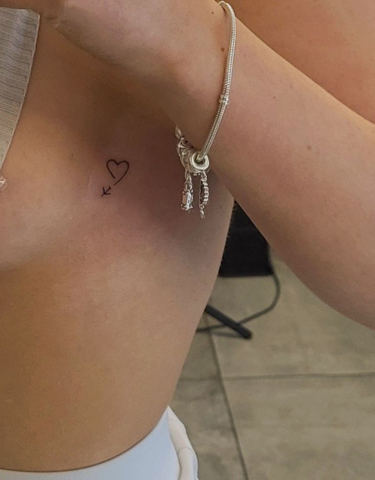 a woman with a small tattoo on her chest