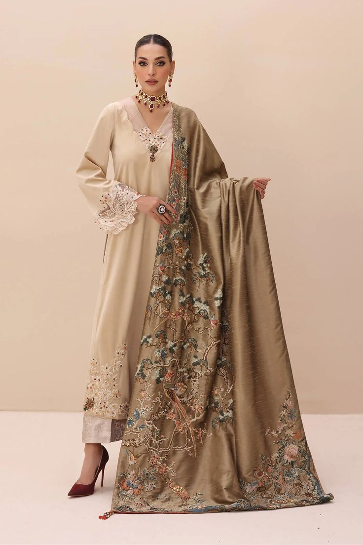 Gold Heavily Embroidered Pakistani Salwar Kameez with Enchanting Shawl a celebration of divine wonders through intricate embroidery techniques. This shawl is a tribute to the organic treasures found in the heart of nature. Its striking design is a canvas of delicate flora and fauna. To add a touch of wild elegance, it features a printed lining that hints at the mysteries of the forest. Adorned with hand-made tassels, lustrous pearls, Swarovski stones, sequins, and exquisite jewel pieces, this en Garden Of Lights, Velvet Dupatta, Pakistani Salwar, Velvet Shawl, Pakistani Salwar Kameez, Velvet Shirt, Swarovski Stones, Gold Silk, Suit Designs