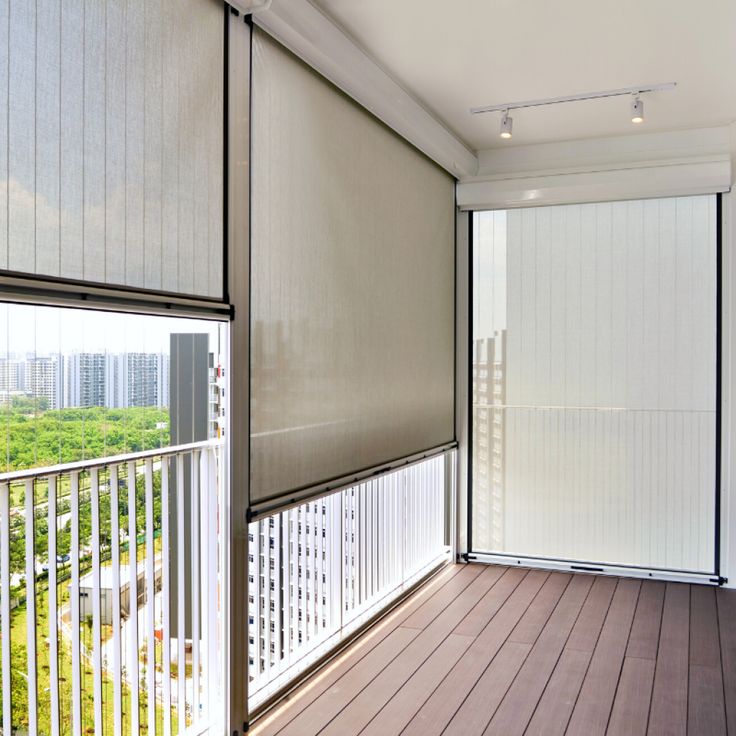 an empty balcony with blinds on the windows