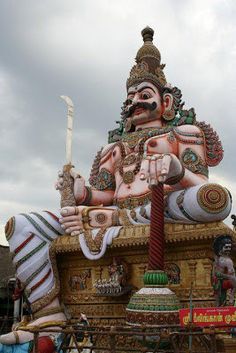 an elaborately decorated statue in the shape of a hindu god on top of a building