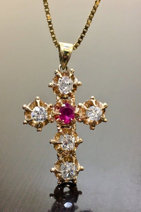 DeKara Designs ClearanceArt Deco Inspired Antique Style 14K Yellow Gold Old European Cut Diamond and Ruby Cross.Metal- 14K Yellow Gold, 14K White Gold, .583.Stones- 5 Antique Old European Cut Diamonds E-F Color VS Clarity, 2.10 Carats, 1 Oval Genuine Ruby 1.20 Carats.  Total Weight of Stones is 3.30 Carats.  This amazing piece is handmade in 14K yellow gold that is Art Deco inspired.  The cross features five antique Old European Cut Diamonds that are colorless, with a beautiful reddish pink oval 14k Gold Cross Jewelry With 17 Jewels, Fine Jewelry 14k Stamped Cross, Yellow Gold Cross Pendant Necklace With Gemstone, Antique Yellow Gold Necklace With Diamond Accents, Luxury Diamond Necklace For Collectors, Collectible Yellow Gold Necklaces With Gemstone, Collectible Diamond Jewelry With 17 Jewels, Hallmarked Yellow Gold Ruby Jewelry, Antique Yellow Gold Cross Pendant Necklace