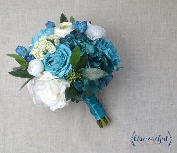 a bridal bouquet with blue and white flowers on a linen background for a wedding