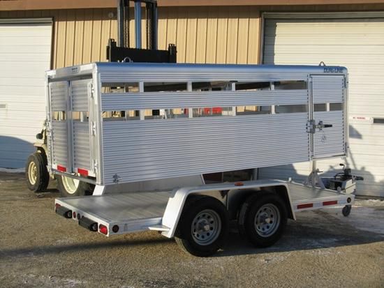 a white trailer parked in front of a building