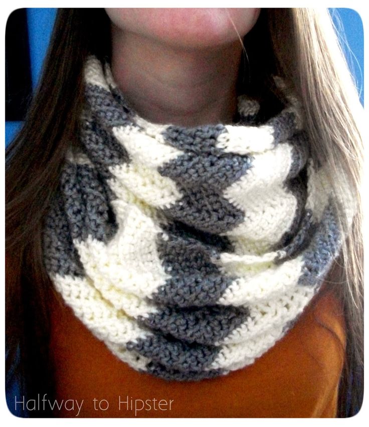 a woman wearing a gray and white cowgirl scarf with black and white crochet