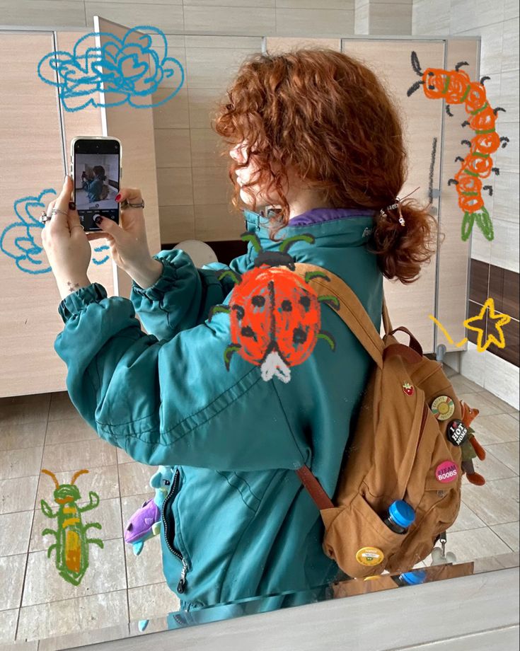 a woman taking a selfie with her cell phone in front of the bathroom mirror