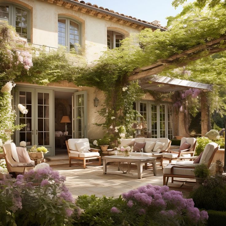 an outdoor living area with furniture and flowers