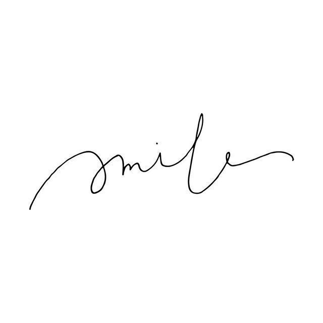 the word smile is written in cursive handwriting on a white background with black ink