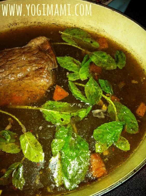 a pot filled with meat and vegetables on top of a stove