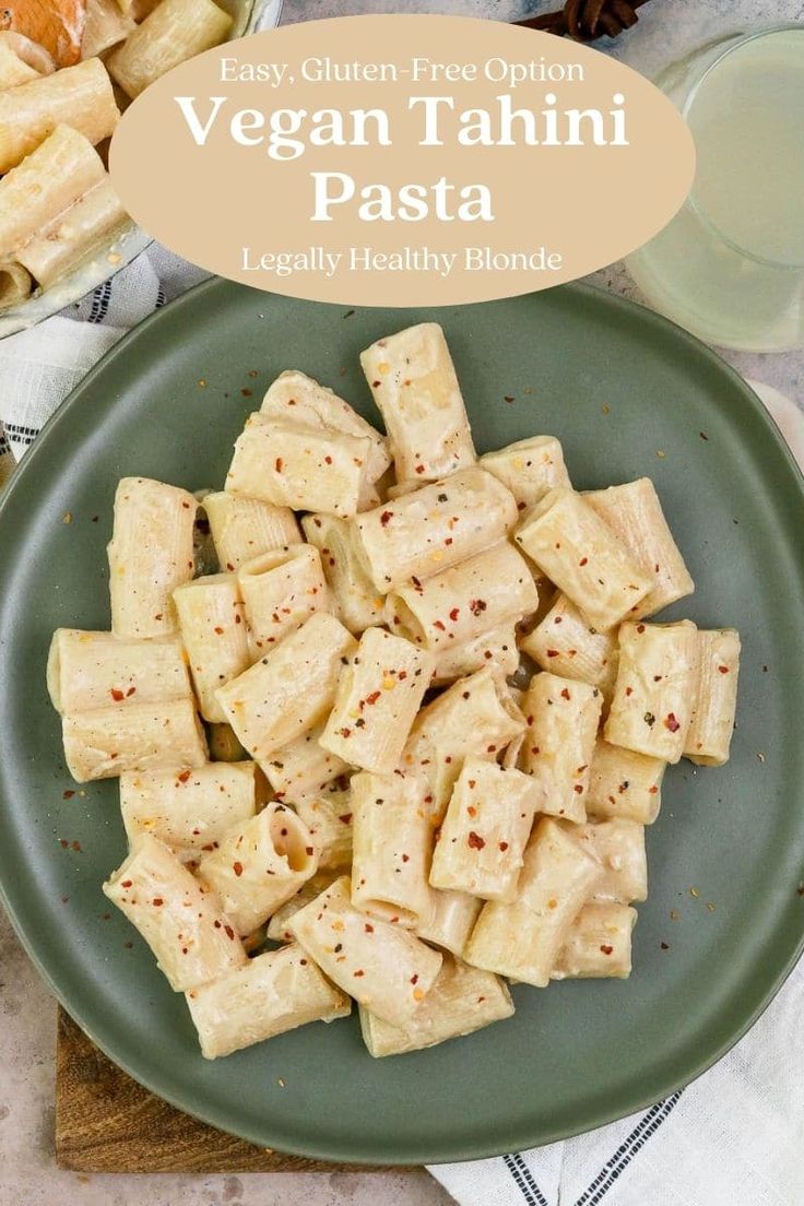 vegan tahitii pasta on a green plate with an orange and white napkin