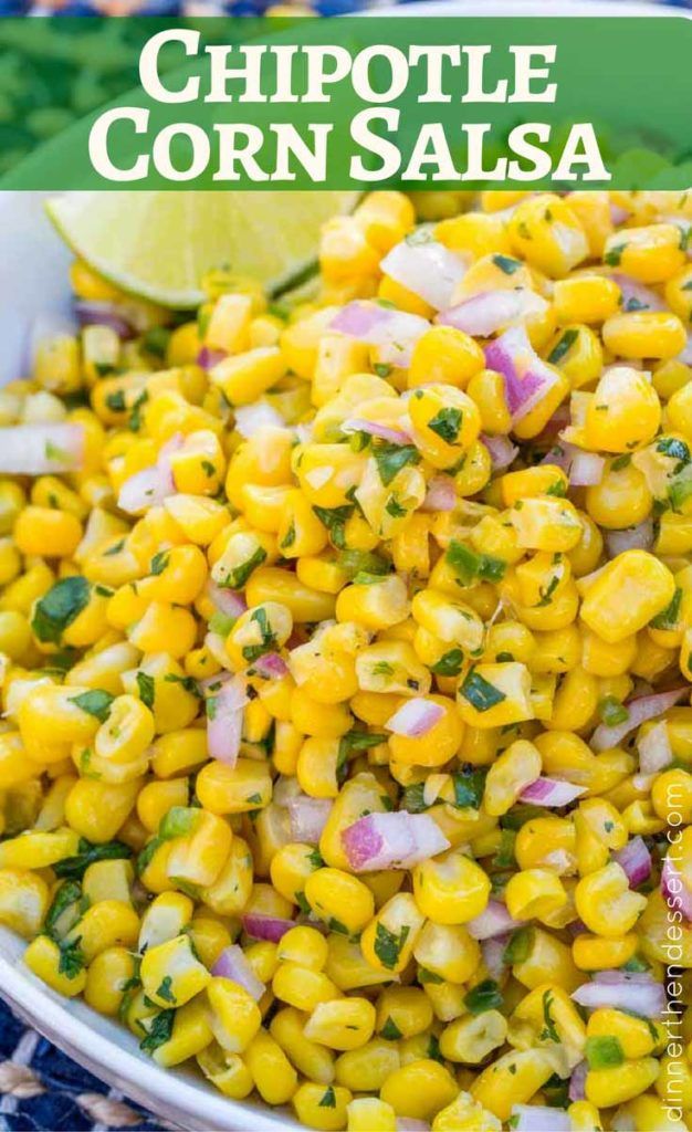 corn salad with cilantro and lime in a white bowl on a blue tablecloth