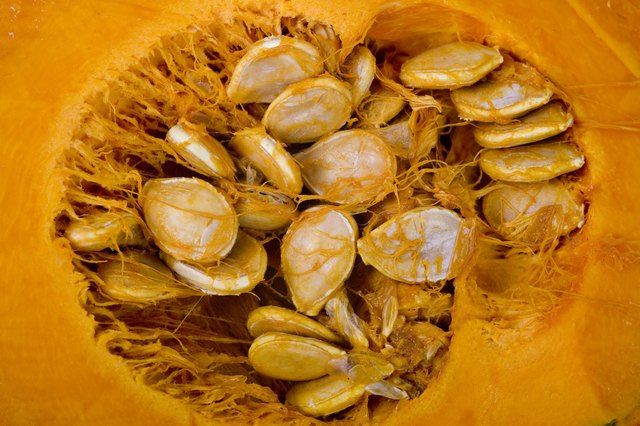 the inside of a pumpkin with seeds in it