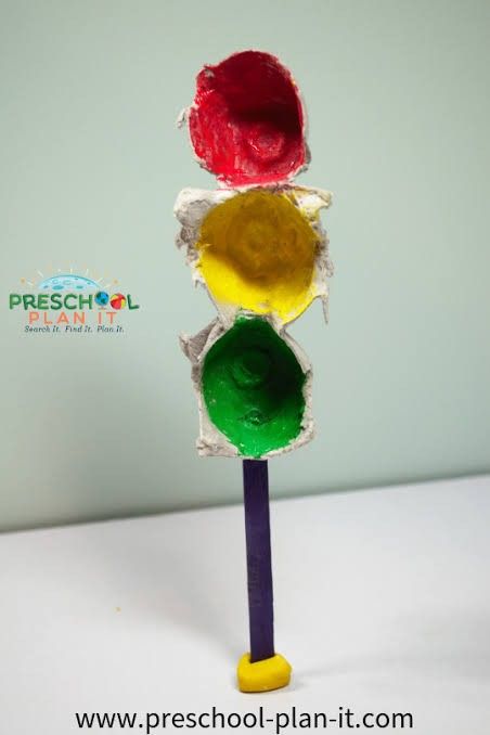 a close up of a traffic light made out of paper and colored crayons