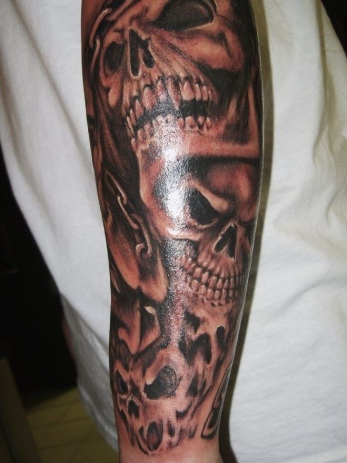 a man with a skull tattoo on his arm