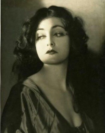 an old black and white photo of a woman with her eyes closed, looking to the side