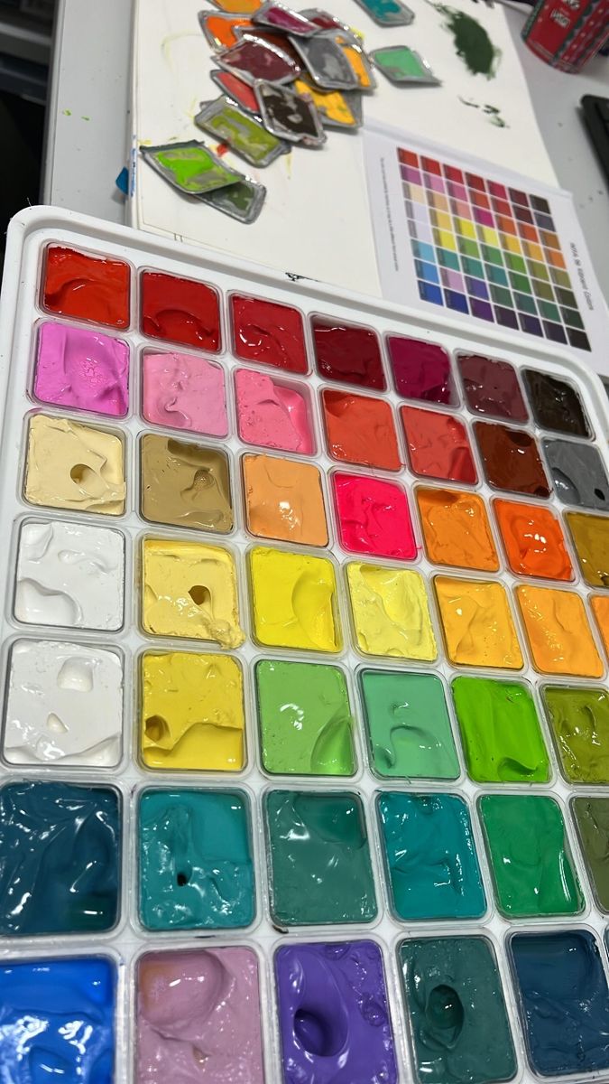 an artist's palette with many colors of paint