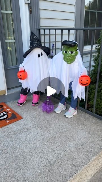 two children dressed up in halloween costumes on the front porch with pumpkins and ghost decorations