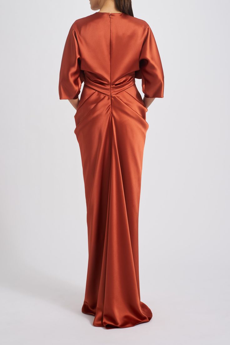 Fluid satin dolman sleeve draped column gown. Shown in Black, Hunter, and Copper. Formal Pre-draped Dress With Gathered Sleeves, Formal Pre-draped Maxi Dress With Pleated Back, Formal Pre-draped Gown With Pleated Back, Pre-draped Silk Evening Dress With Folds, Pre-draped Silk Evening Dress With Pleated Back, Elegant Formal Evening Dress With Gathered Sleeves, Formal Floor-length Gown With Draped Sleeves, Formal Evening Dress With Draped Sleeves, Formal Floor-length Evening Dress With Draped Sleeves