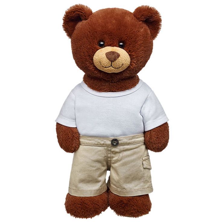 a brown teddy bear wearing a white shirt and tan shorts with his hands in his pockets