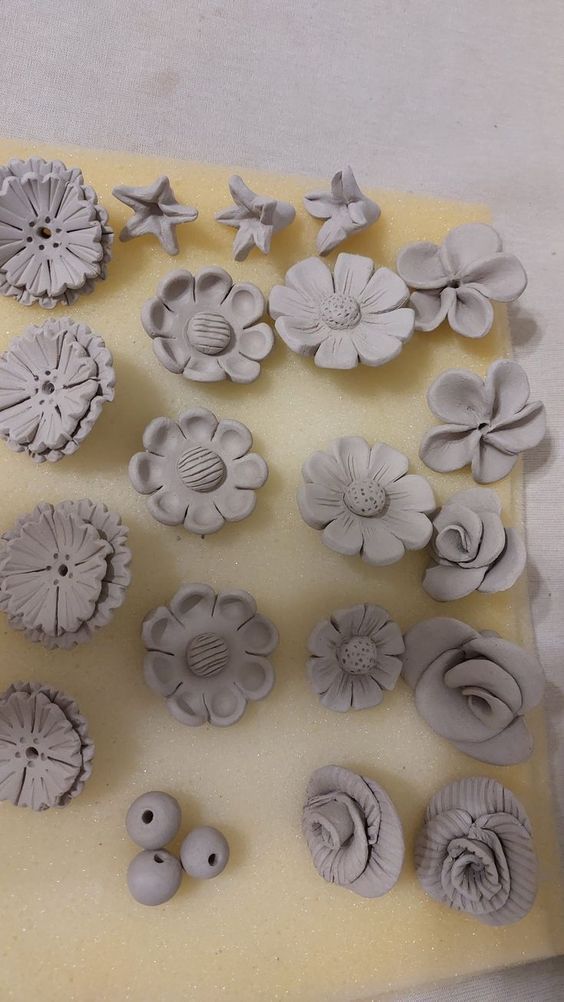 a bunch of different shapes and sizes of flowers on a sheet of white wax paper