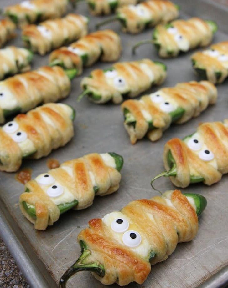 some food is on a pan and ready to be cooked in the oven with eyes drawn on them