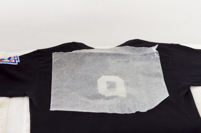 a t - shirt that has been taped to the side with clear plastic on it