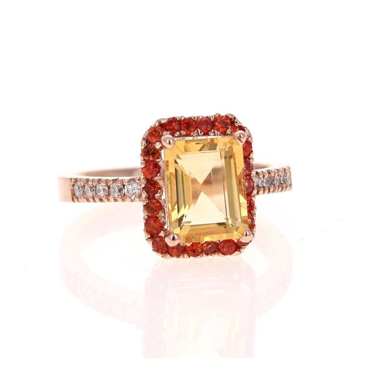 This gorgeous ring has a beautiful Emerald Cut Citrine Quartz weighing 2.23 Carats and is surrounded by a Halo of 22 Round Cut Orange Sapphires weighing 0.50 Carats. Along the shank of the ring are 10 Round Cut Diamonds that weigh 0.18 Carats (Clarity: SI2, Color: F). The total Carat weight is 3.35 Carats.  It is set in 14K Rose Gold and weighs approximately 4.9 grams. This ring is a size 7  Exact dimensions for this item are unknown. Please reach out in the seller Q&A for any questions on measu Yellow Halo Ring Jewelry, Yellow Halo Rings As A Gift, Orange Jewelry With Accent Stones For Anniversary, Orange Anniversary Jewelry With Accent Stones, Elegant Orange Rings With Gemstone Accents, Yellow Sapphire Rings With Gemstone Accents As Gift, Fine Jewelry Orange Center Stone, Fine Jewelry With Orange Center Stone, Classic Orange Jewelry With Accent Stones