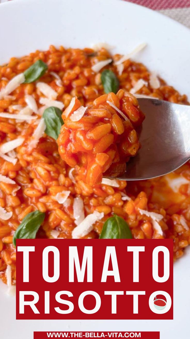 tomato risotto with basil and parmesan cheese in a white bowl on a red checkered tablecloth