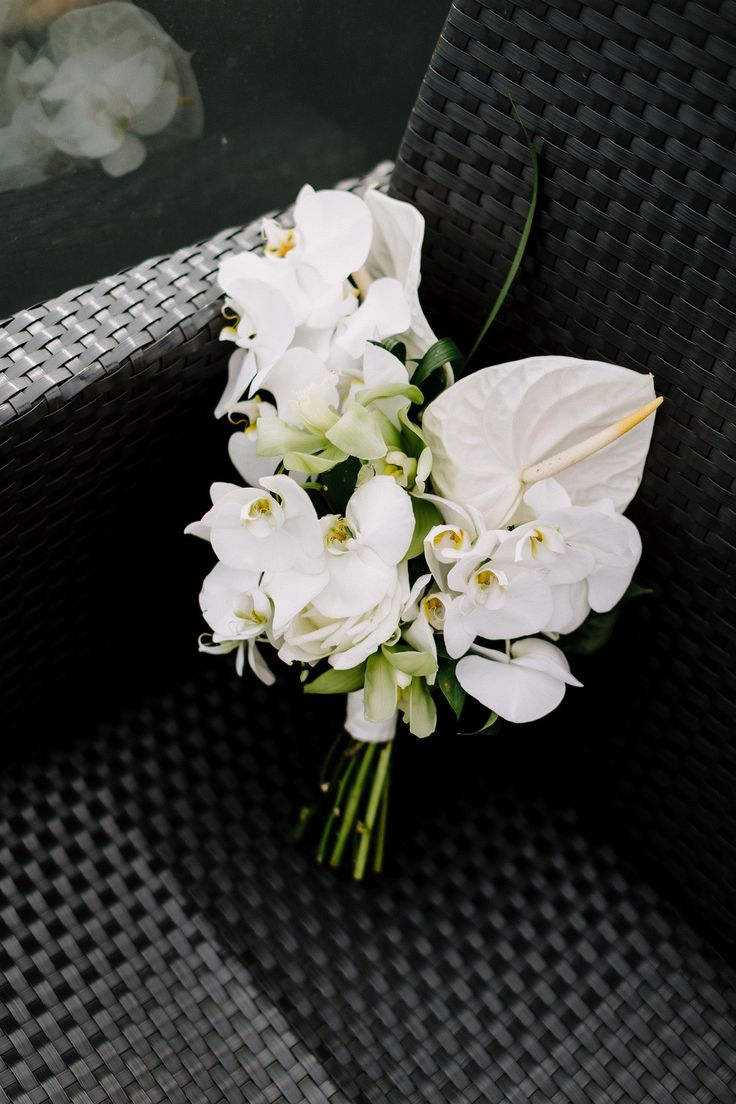 a bouquet of white flowers sitting on top of a chair