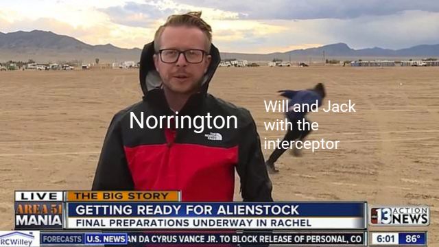 the news reporter is wearing a hoodie and standing in front of an empty beach