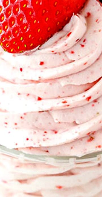 a close up of a cake with strawberries on top