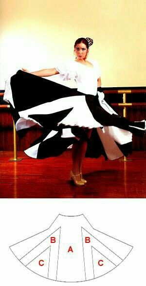 a woman in a black and white dress is standing on a wooden floor with her legs spread out