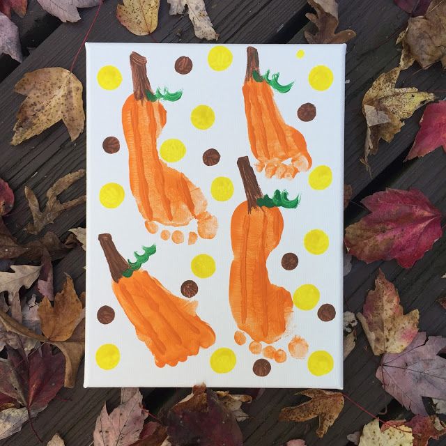 a card with handprinted pumpkins and polka dotes on it, surrounded by leaves