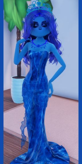 a blue doll wearing a tiara standing on a table