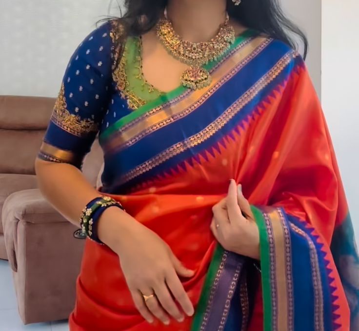 a woman in a red and blue sari