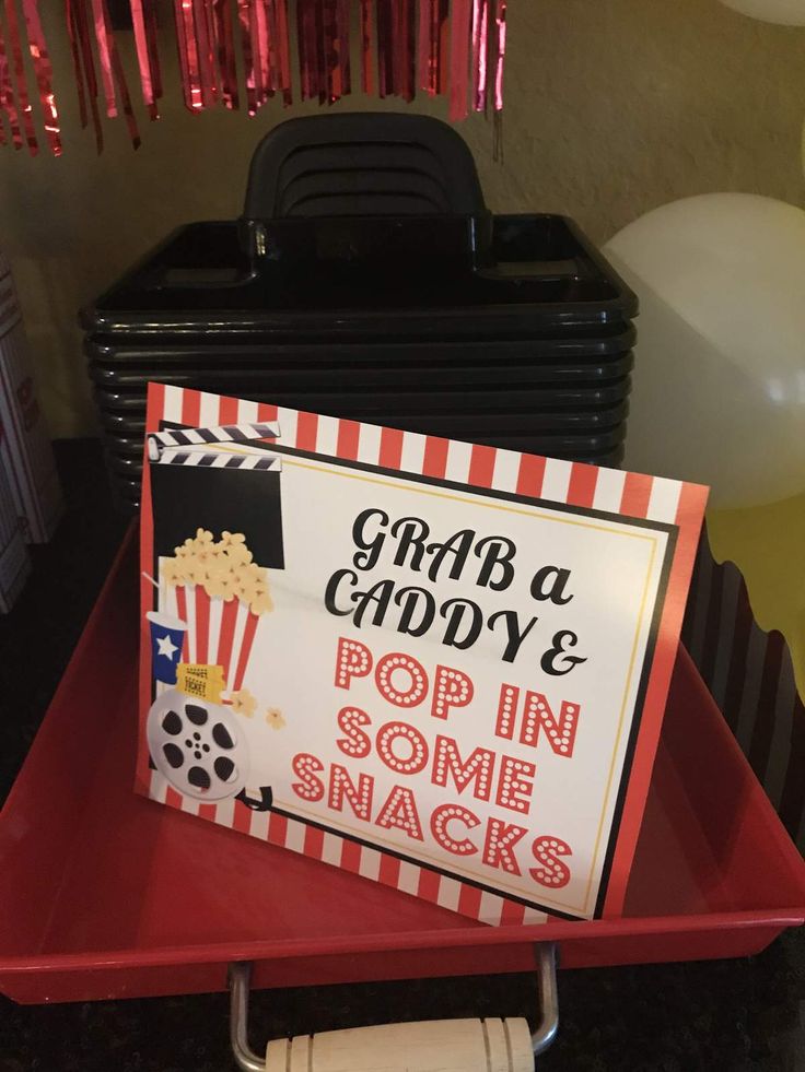 there is a sign that says grab a goody and pop in some snacks on the table