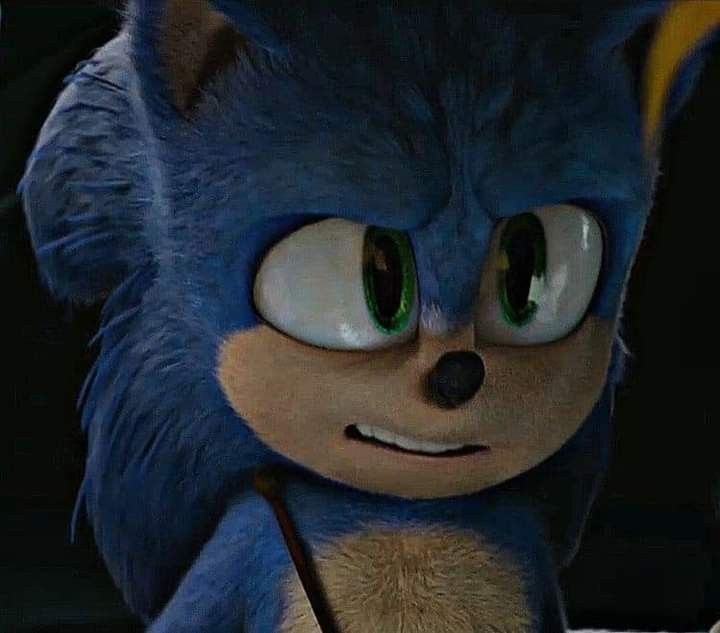 a close up of a sonic the hedgehog character with green eyes and an angry look on his face