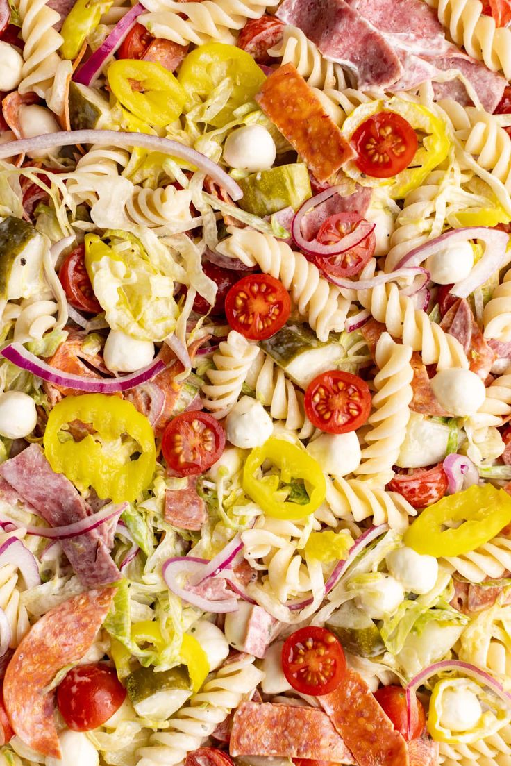 pasta salad with ham, tomatoes, onions and cheese