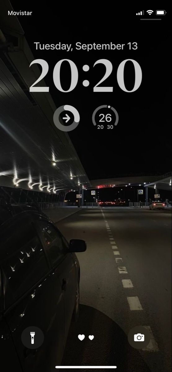 a car driving down a street at night with the date on it's screen