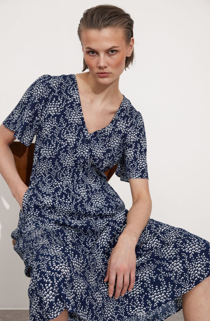 A delightfully dainty floral print enhances the airy style of a V-neck midi dress complete with gently fluttered sleeves. Front button closure V-neck Short sleeves Unlined 100% viscose Dry clean Imported Puff Sleeve Cardigan, Summer Style Guide, Low Waist Jeans, Floral Print Midi Dress, V Neck Midi Dress, Print Midi Dress, Navy Midi Dress, Wool Turtleneck, Mini Velvet Dress