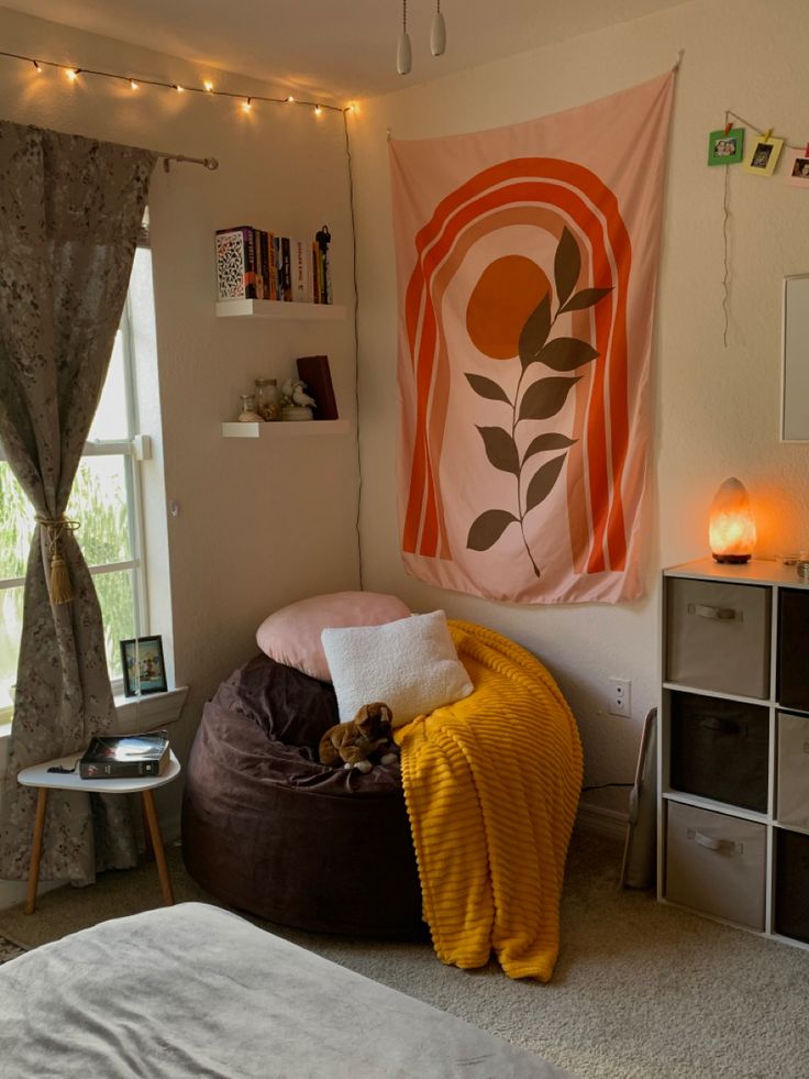 a bed room with a large poster hanging above it's headboard and pillows on the floor