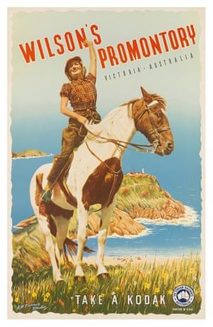 a boy riding on the back of a brown and white horse next to an ocean