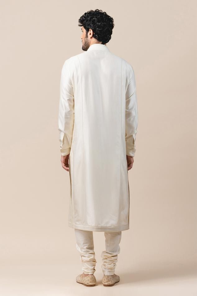 Ivory straight long kurta with side slits, concealed placket, textured border and cuff sleeves. Comes with churidar.
Component: 2
Neckline: Mandarin Collar
Sleeve Length: Full
Fabric: Katan Silk, Poplin Lycra
Color: White
Concealed placket
Side slits
Cuff sleeves - Aza Fashions Kurta Set Men, Silk Kurta Set, Kurta Set For Men, Men Kurta, Long Kurta, Silk Kurta, Tarun Tahiliani, Katan Silk, Churidar