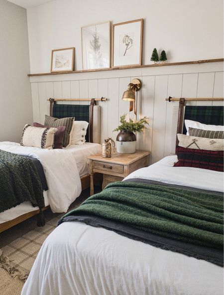 two beds in a room with white walls and wooden headboards on either side of them