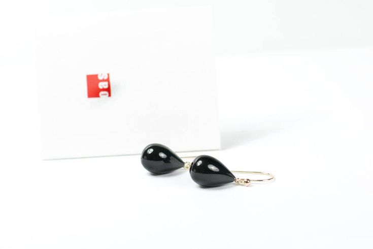 "Solid Gold Black Onyx Waterdrop Earrings by oas New York™ \"YOU ARE WHAT YOU WEAR\" Your choice of adornment is a reflection of who you are - it resonate with your inner desire towards a unique identity, as it is a gentle attempt to accomplish something possible in this impossible thing we know as life. Product Details: Condition: brand new Gem: black onyx Gem Size: 18mm x 10mm Weight: 4.8 gram / 24 carat per pair Length: hangs about 1 inch from your ear Metal Components: solid 14K or 18K yello Black Drop Earrings For Formal Occasions, Teardrop Black Enamel Earrings For Gift, Classic Black Teardrop Earrings, Black Enamel Teardrop Earrings For Gift, Elegant Black Everyday Earrings, Black Drop Earrings For Gift, Classic Black Drop Jewelry, Minimalist Black 14k Gold Earrings, Modern Black Drop Earrings