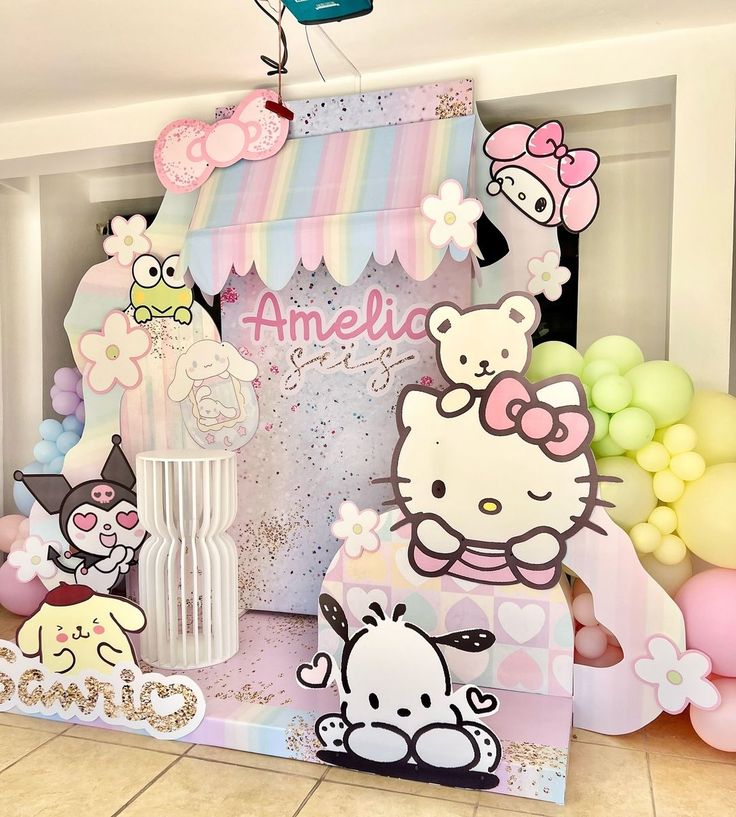 a hello kitty birthday party with balloons and decorations