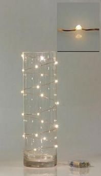 a glass vase with some lights in it